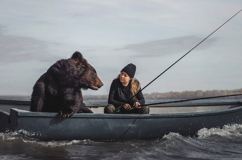  The woman enjoys fishing with the bear she had saved